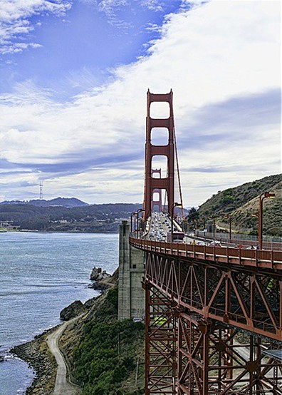 Golden Gate Bridge under a cloudy blue sky