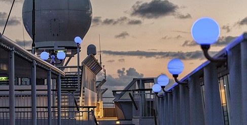 Ship deck with glowing blue lamps at dusk